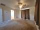 Spacious bedroom with plush carpeting, ceiling fan, and large window at 165 W Alma Ave, Overton, NV 89040