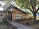 Home exterior view highlighting a front yard, sidewalk, and mature trees at 165 W Alma Ave, Overton, NV 89040