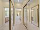 Bathroom hallway featuring mirror sliding closet doors and tile flooring at 2033 Summer Spruce Pl # 102, Las Vegas, NV 89134