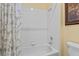 Bathroom highlighting tub with white tile and gray and white floral curtain at 2033 Summer Spruce Pl # 102, Las Vegas, NV 89134