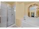 Bright bathroom showcasing a glass shower and soaking tub at 2033 Summer Spruce Pl # 102, Las Vegas, NV 89134