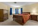 Bedroom featuring neutral carpeting, yellow walls, and classic wood furniture at 2033 Summer Spruce Pl # 102, Las Vegas, NV 89134