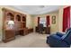 Bright bedroom featuring neutral carpeting, yellow walls, red curtains, and classic wood desk at 2033 Summer Spruce Pl # 102, Las Vegas, NV 89134