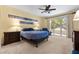Comfortable bedroom with a ceiling fan, neutral carpet, and sliding glass doors to backyard at 2033 Summer Spruce Pl # 102, Las Vegas, NV 89134