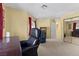 Bright bedroom featuring neutral carpeting, yellow walls, red curtains, and desk at 2033 Summer Spruce Pl # 102, Las Vegas, NV 89134