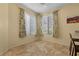 Bright dining area with tile flooring and views of the backyard through large windows at 2033 Summer Spruce Pl # 102, Las Vegas, NV 89134