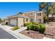 Charming two-story house featuring landscaped front yard and a two car garage at 2033 Summer Spruce Pl # 102, Las Vegas, NV 89134