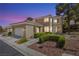 Inviting home exterior showcasing a 2-car garage and manicured landscaping at 2033 Summer Spruce Pl # 102, Las Vegas, NV 89134