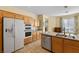 Bright kitchen with stainless steel appliances, granite countertops, and wood cabinets at 2033 Summer Spruce Pl # 102, Las Vegas, NV 89134