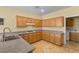 Functional kitchen featuring wood cabinetry, granite countertops, and gas range at 2033 Summer Spruce Pl # 102, Las Vegas, NV 89134