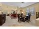 Open-concept living area with large windows and a dining set for entertaining at 2033 Summer Spruce Pl # 102, Las Vegas, NV 89134