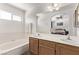 Bright bathroom featuring double sinks, a bathtub, a large mirror and neutral paint at 2037 Merano Ct, Las Vegas, NV 89123