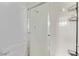 Shower stall with glass door, white tiles and storage racks in a modern bathroom at 2037 Merano Ct, Las Vegas, NV 89123