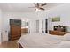 Bedroom features a ceiling fan, wood floors, and an attached bathroom and closet at 2037 Merano Ct, Las Vegas, NV 89123