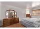 Bedroom with hardwood floors, a triple dresser with mirror, and natural light at 2037 Merano Ct, Las Vegas, NV 89123