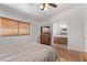 Bedroom features a ceiling fan, wood floors, and an attached bathroom at 2037 Merano Ct, Las Vegas, NV 89123