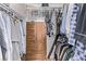 Walk-in closet features ample storage and clothing racks with wooden cabinet and drawers at 2037 Merano Ct, Las Vegas, NV 89123