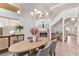 Bright dining room features a modern chandelier, fireplace, and staircase at 2037 Merano Ct, Las Vegas, NV 89123