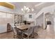Traditional dining room with a rustic chandelier, tile floors, and staircase at 2037 Merano Ct, Las Vegas, NV 89123