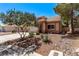 Attractive two-story home featuring a two-car garage and well-maintained desert front yard landscaping at 2037 Merano Ct, Las Vegas, NV 89123