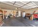Photo of a spacious garage interior features storage, a workbench, water heater, and an automatic overhead door at 2037 Merano Ct, Las Vegas, NV 89123