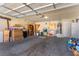 Spacious garage with ample storage, workbench area, water heater, and overhead door with opener at 2037 Merano Ct, Las Vegas, NV 89123