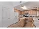Well-lit kitchen with oak cabinets, white appliances, and a functional island at 2037 Merano Ct, Las Vegas, NV 89123