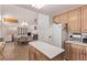Open kitchen and dining area with oak cabinets and tile floors at 2037 Merano Ct, Las Vegas, NV 89123