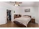 Comfortable bedroom features a ceiling fan, dark wood furniture and a walk-in closet at 2037 Merano Ct, Las Vegas, NV 89123