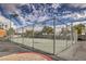Outdoor basketball court secured by a chain link fence and adjacent parking at 2120 Ramrod Ave # 2216, Henderson, NV 89014