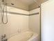 Clean bathroom with shower and tub featuring white tile with gray trim at 2120 Ramrod Ave # 2216, Henderson, NV 89014