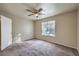 Bedroom features a ceiling fan, carpet, and a large window that lets in plenty of natural light at 2120 Ramrod Ave # 2216, Henderson, NV 89014