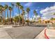 Community entrance with tall palm trees lining the street and manicured landscaping at 2120 Ramrod Ave # 2216, Henderson, NV 89014
