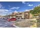 Apartment building with covered parking, patios and mature landscaping under a blue sky at 2120 Ramrod Ave # 2216, Henderson, NV 89014