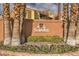Solevita Condominium Homes sign at the entrance surrounded by tall palm trees and flower beds at 2120 Ramrod Ave # 2216, Henderson, NV 89014