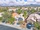 Aerial view of single-story home featuring a two-car garage, desert landscaping, and a tile roof at 2271 Smokey Sky Dr, Henderson, NV 89052