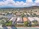 A residential community with mature trees and desert landscaping against a backdrop of mountains and sky at 2271 Smokey Sky Dr, Henderson, NV 89052
