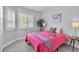 Bright bedroom with two windows, plantation shutters, and a cozy pink quilt on the bed at 2271 Smokey Sky Dr, Henderson, NV 89052