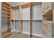 Spacious walk-in closet featuring custom wood shelving, drawers and metal clothing racks at 2271 Smokey Sky Dr, Henderson, NV 89052
