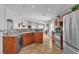Open kitchen with stainless steel appliances, wooden cabinetry, and view of connected living space at 2271 Smokey Sky Dr, Henderson, NV 89052