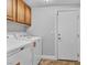 Laundry room includes a washer, dryer and cabinetry for storage, and utility sink at 2271 Smokey Sky Dr, Henderson, NV 89052