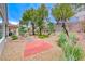 Backyard featuring mature trees, low-maintenance gravel, a brick patio and manicured shrubs at 2522 Darda St, Henderson, NV 89044