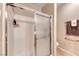 Updated bathroom featuring a glass door shower and a towel rack at 2522 Darda St, Henderson, NV 89044