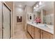 Updated bathroom with dual sinks, framed mirrors, and a glass door shower at 2522 Darda St, Henderson, NV 89044
