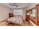 This bedroom features hardwood floors, a ceiling fan, and plantation shutters at 2522 Darda St, Henderson, NV 89044