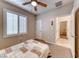 This bedroom has neutral carpeting, a ceiling fan, and a walk-in closet at 2522 Darda St, Henderson, NV 89044