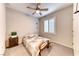 This bedroom has neutral carpeting, a ceiling fan, and plantation shutters at 2522 Darda St, Henderson, NV 89044