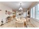 Cozy dining area with a wood table, cushioned chairs, and bright natural light from large window at 2522 Darda St, Henderson, NV 89044