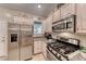 The kitchen boasts stainless steel appliances and ample cabinet space, perfect for cooking enthusiasts at 2522 Darda St, Henderson, NV 89044