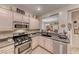 This kitchen features granite countertops, stainless steel appliances, and an adjacent living area at 2522 Darda St, Henderson, NV 89044